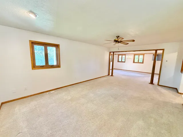 an empty room with windows and closet