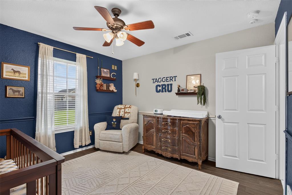 100 Radecke Road Krum, TX 76249 - Photo 22 of 29 Interior room featuring dark wood-finish flooring and a ceiling fan with integrated lighting
