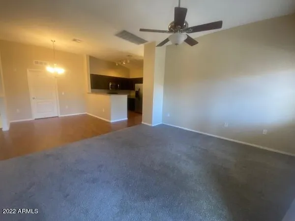 a view of a livingroom with a ceiling fan and window