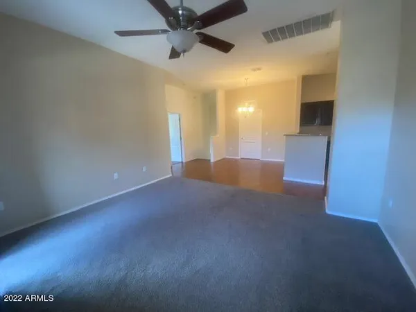 a view of a livingroom with a ceiling fan and window