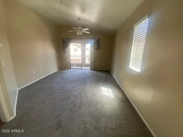 an empty room with stairs and windows