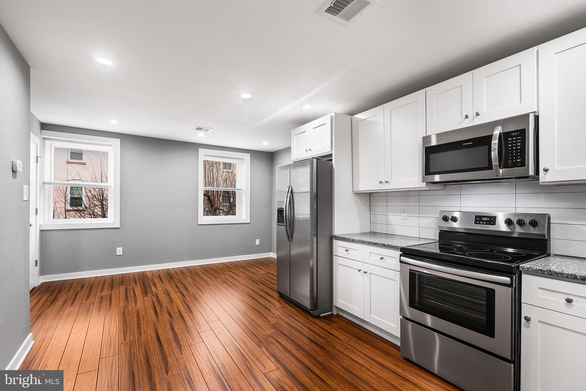 2125 North 20th Street, Unit 2 Philadelphia, PA 19121 - Photo 1 of 20 a kitchen with wooden floors and black appliances