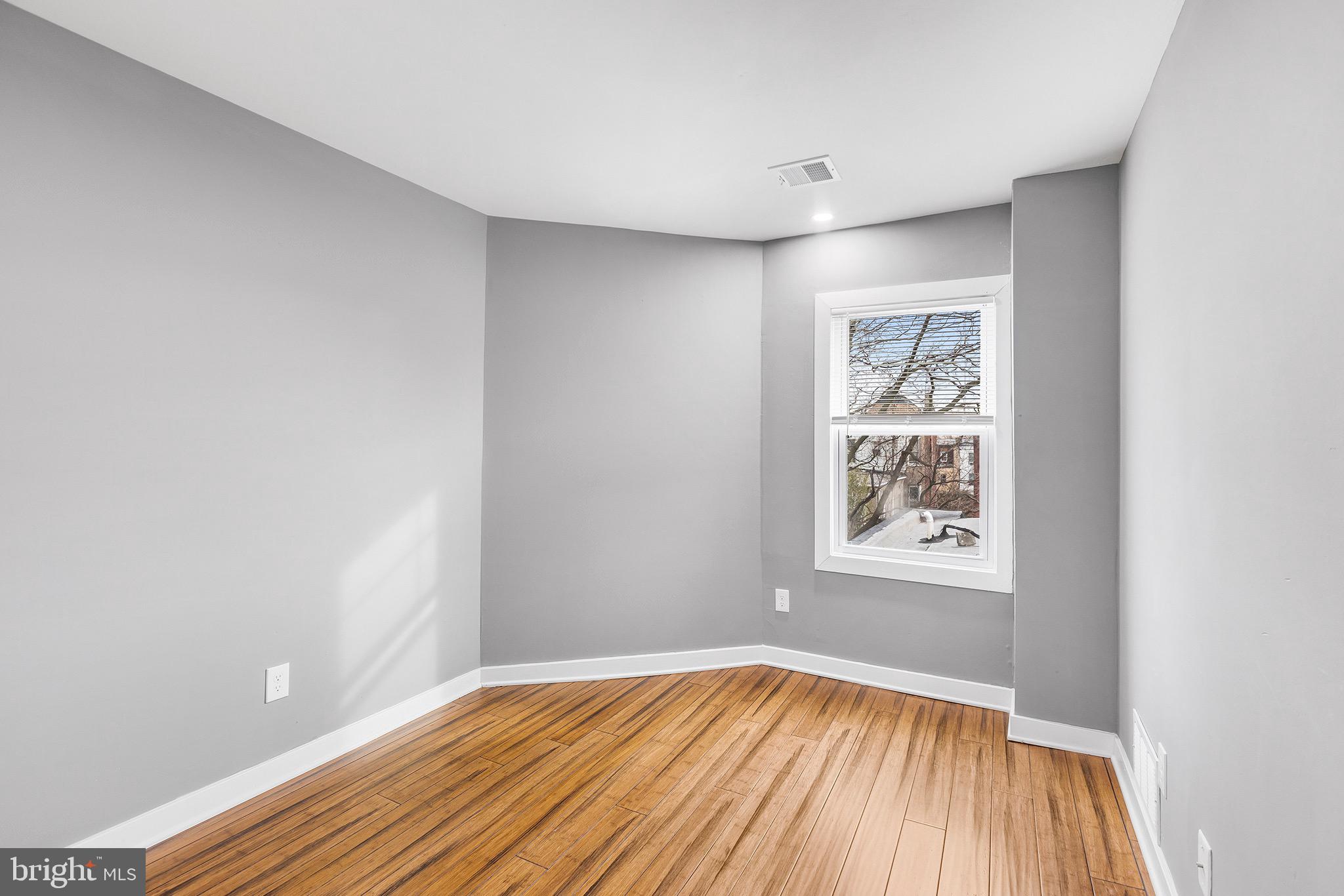 2125 North 20th Street, Unit 2 Philadelphia, PA 19121 - Photo 11 of 20 a view of room with window and wooden floor