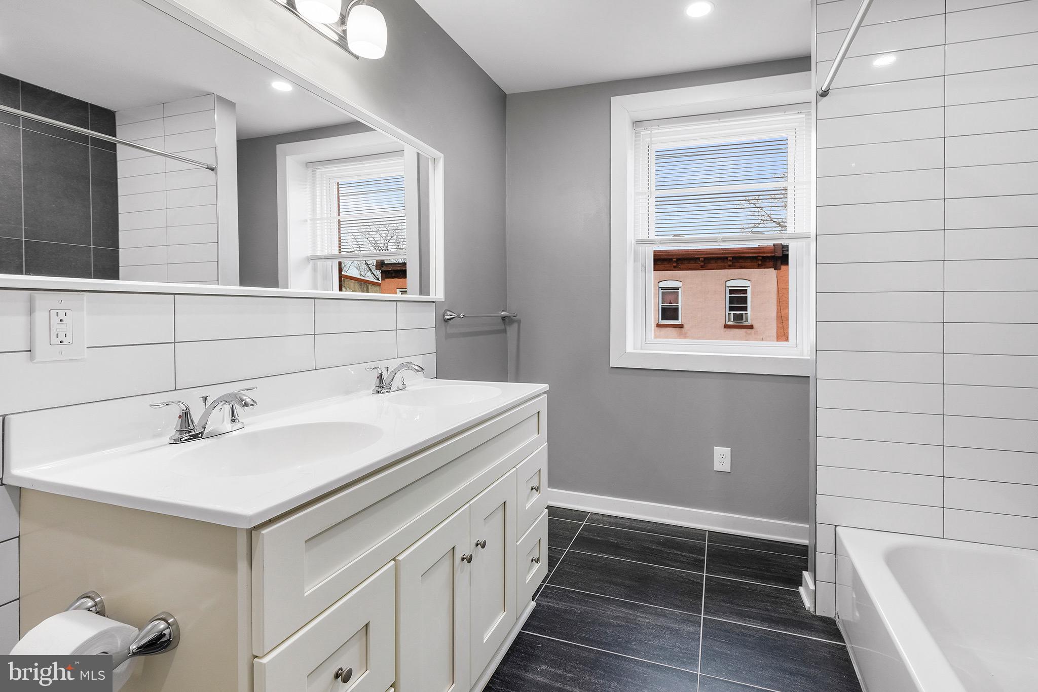 2125 North 20th Street, Unit 2 Philadelphia, PA 19121 - Photo 13 of 20 a bathroom with a sink and a bathtub