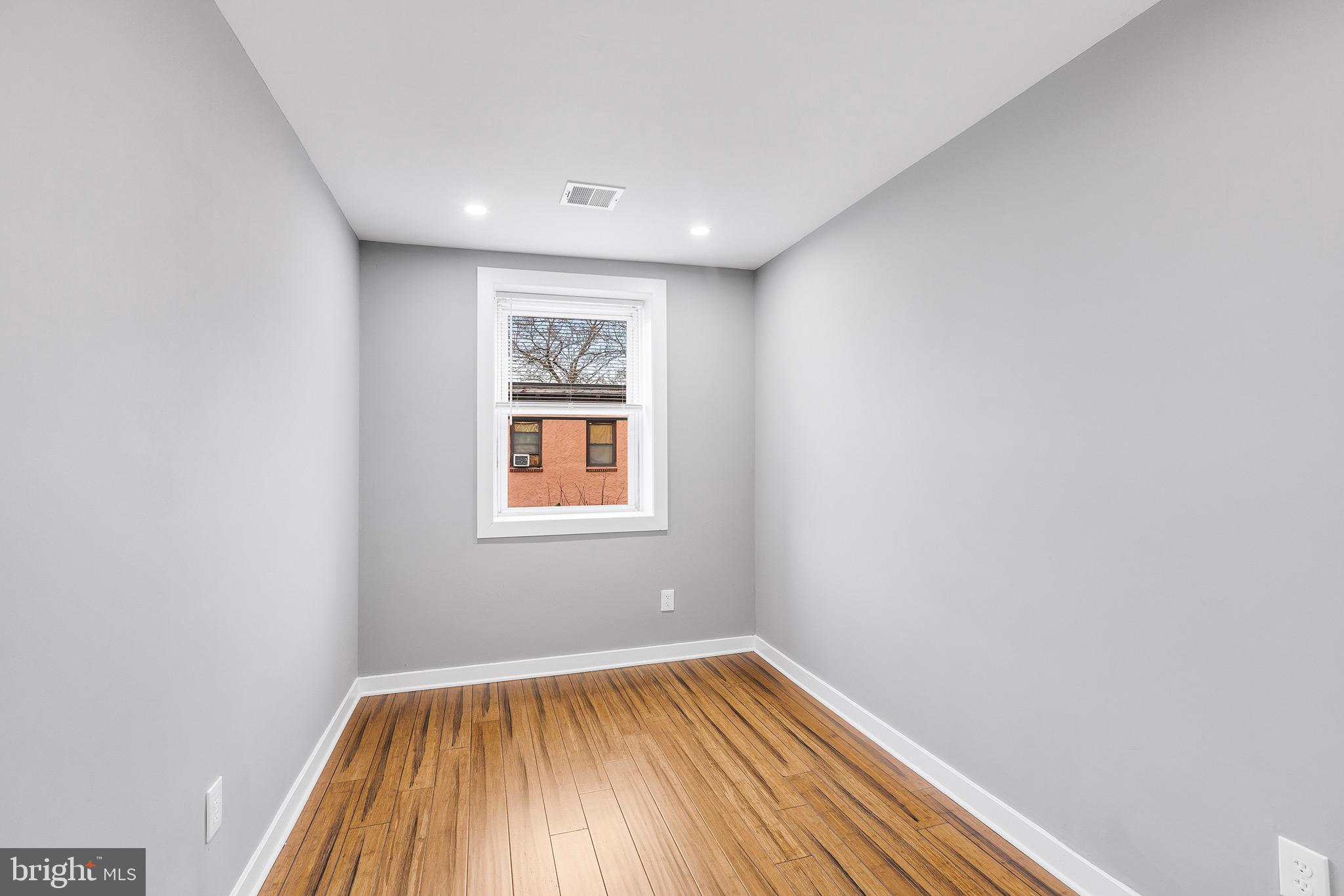 2125 North 20th Street, Unit 2 Philadelphia, PA 19121 - Photo 15 of 20 a view of room with window and wooden floor