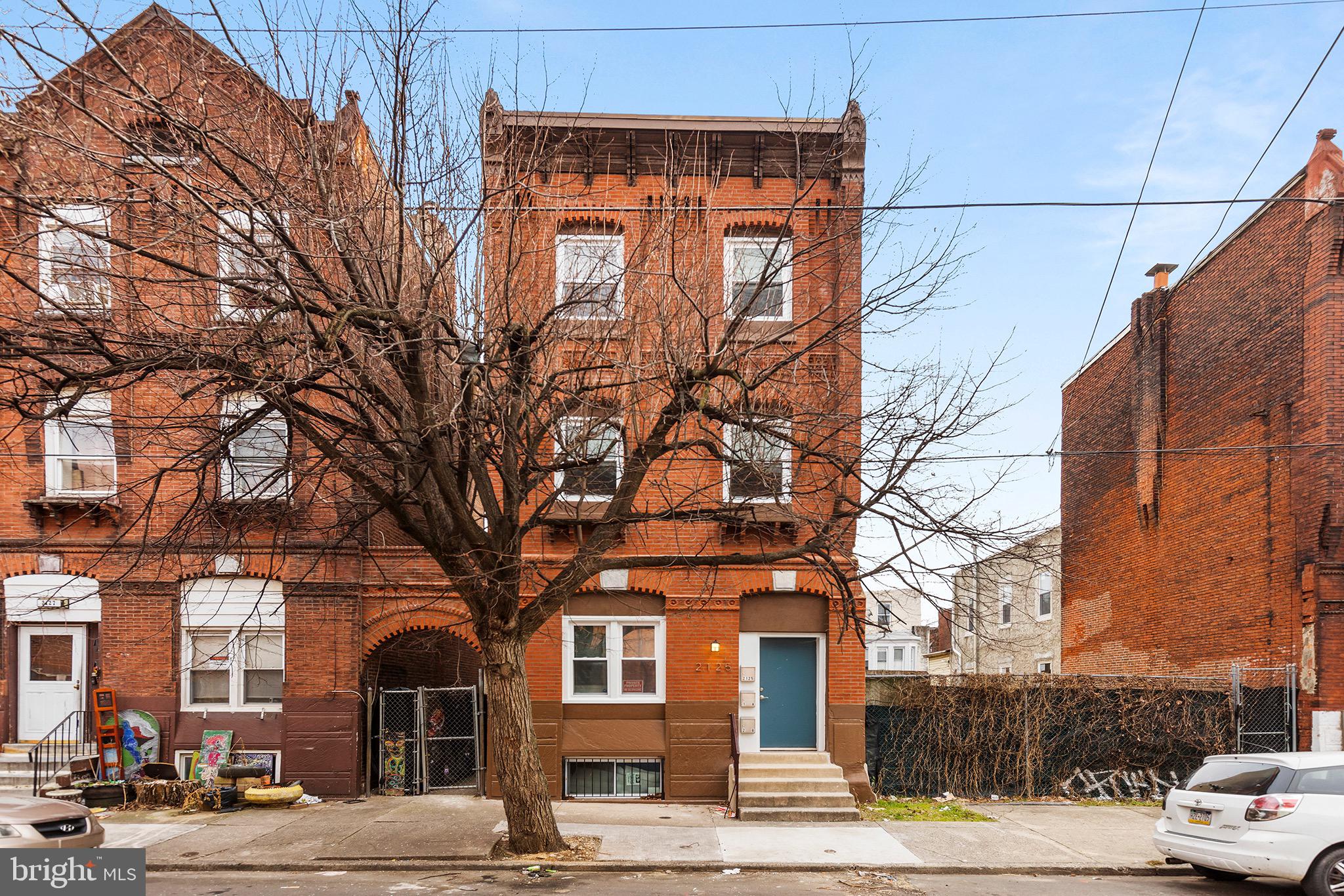 2125 North 20th Street, Unit 2 Philadelphia, PA 19121 - Photo 19 of 20 a front view of a building with large trees