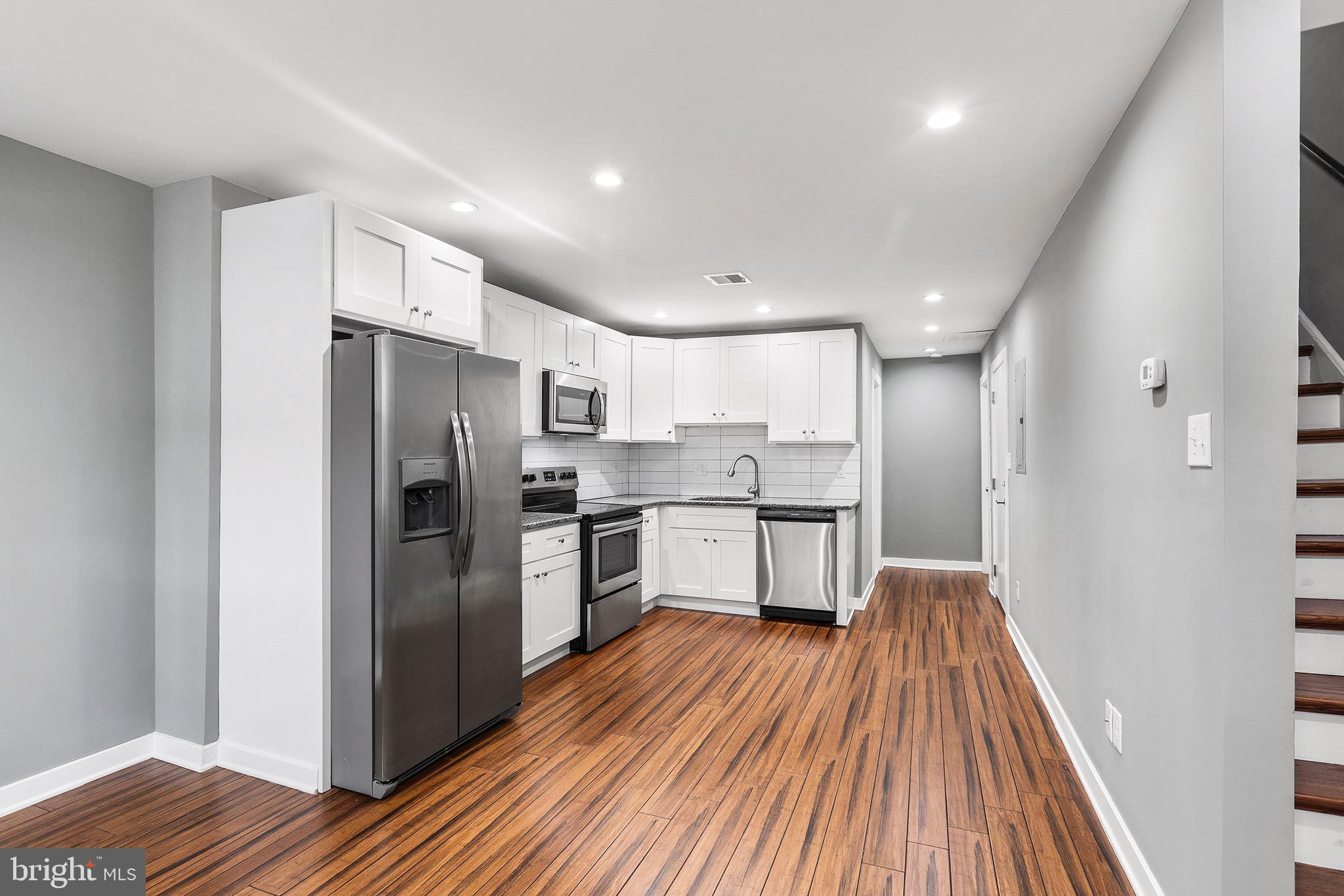 2125 North 20th Street, Unit 2 Philadelphia, PA 19121 - Photo 4 of 20 a kitchen with stainless steel appliances a refrigerator sink and cabinets