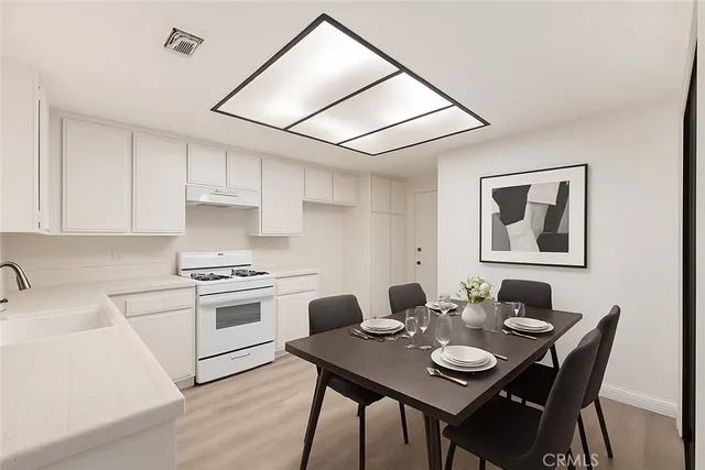 a open dining room with furniture and wooden floor