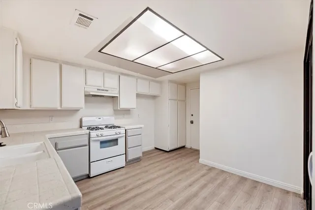a kitchen with a stove and a refrigerator