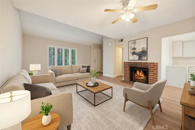 a living room with furniture a fireplace and a chandelier