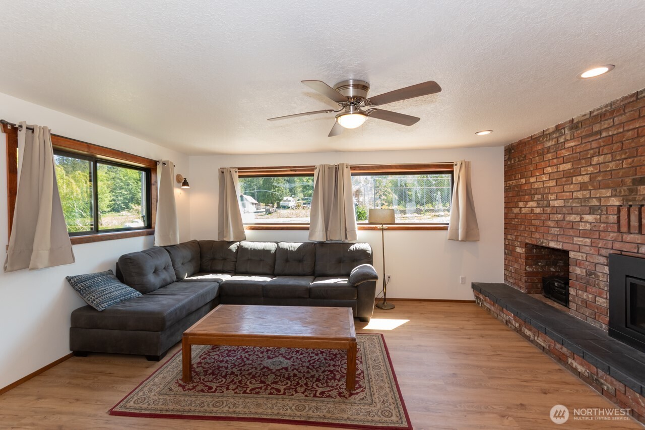 63 East Arnette Road Port Angeles, WA 98362 - Photo 20 of 40 a living room with furniture a window and a fireplace