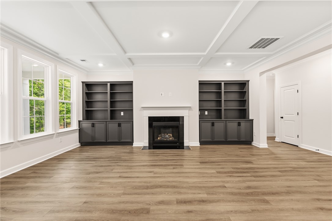 705 Weathered Oak Way Anderson, SC 29621 - Photo 18 of 47 This bright living space features built-in shelving, a cozy fireplace, and ample natural light.