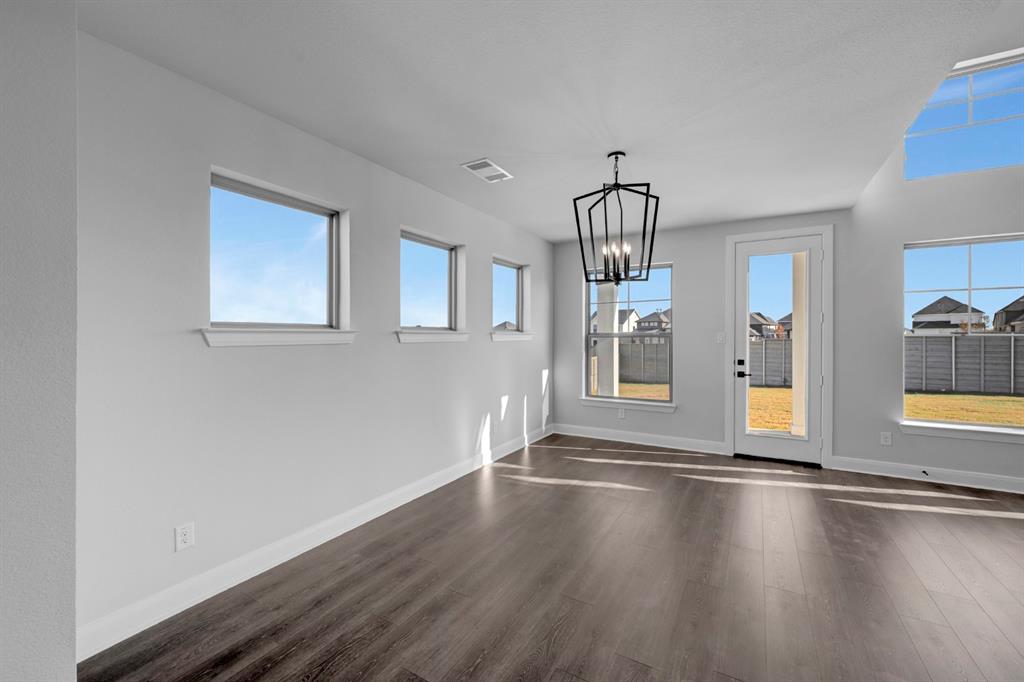 9004 Chestnut Lane Justin, TX 76247 - Photo 25 of 40 a view of empty room with wooden floor and fan