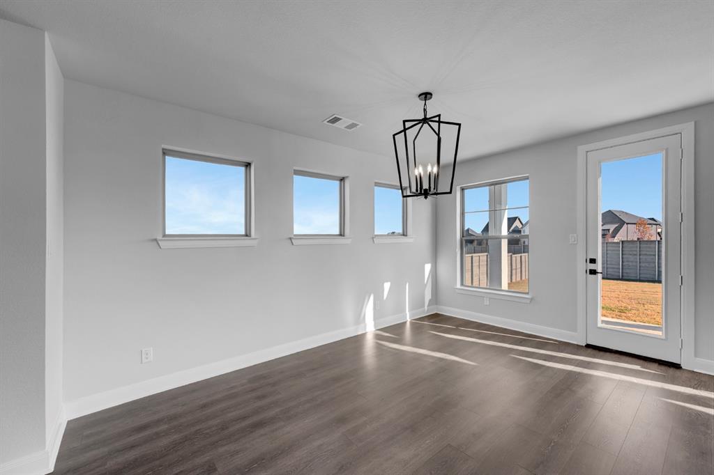 9004 Chestnut Lane Justin, TX 76247 - Photo 26 of 40 a view of an empty room with wooden floor and a window