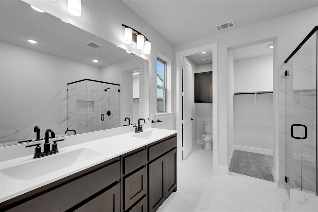 9004 Chestnut Lane Justin, TX 76247 - Photo 39 of 40 a bathroom with a double vanity sink mirror and shower