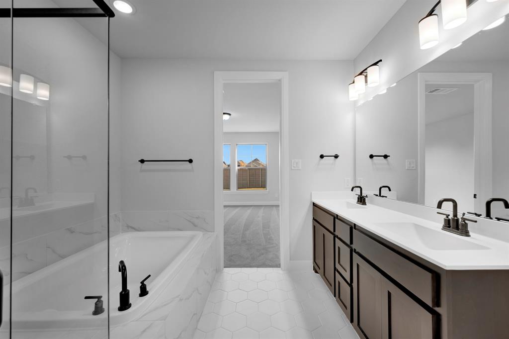 9004 Chestnut Lane Justin, TX 76247 - Photo 40 of 40 a bathroom with a tub sink shower and mirror