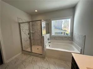 a bathroom with a bathtub and a shower