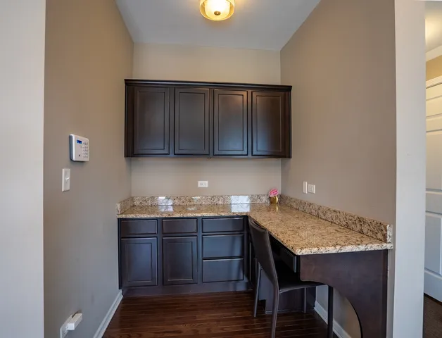 a kitchen with a sink cabinets and wooden floor