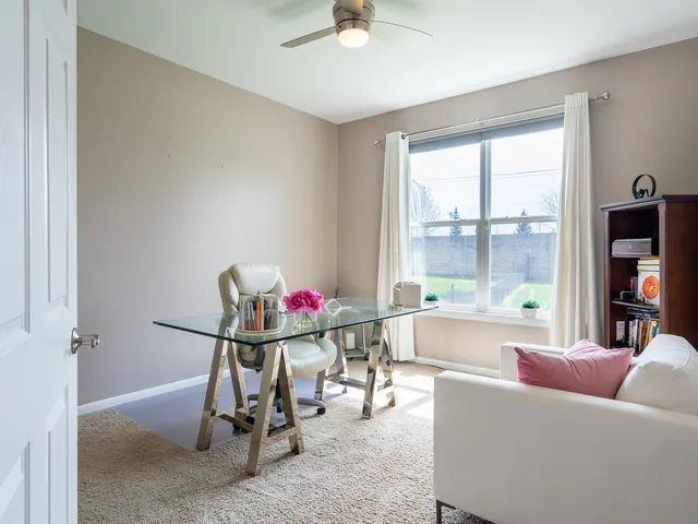 a work room with furniture and a large window