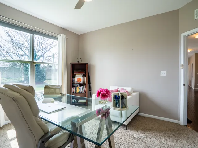 a living room with furniture and a floor to ceiling window