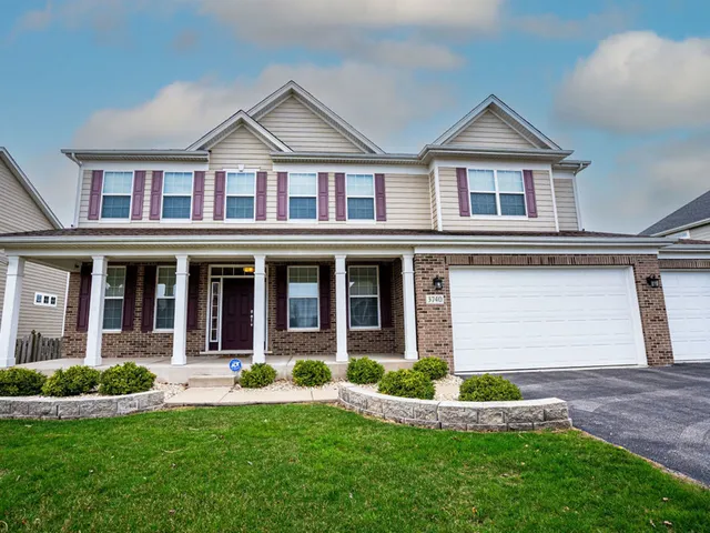 a front view of a house with a yard and porch
