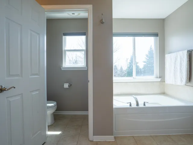 a bathroom with a bathtub and a toilet