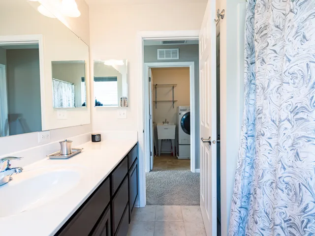 a en suite bathroom with a sink and a mirror
