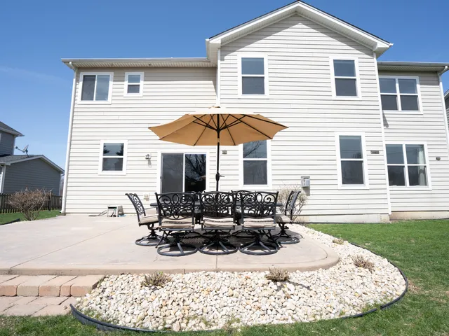 a view of a house with yard and sitting area