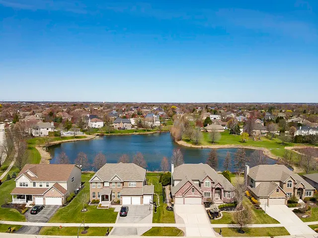 an aerial view of a house with a lake view