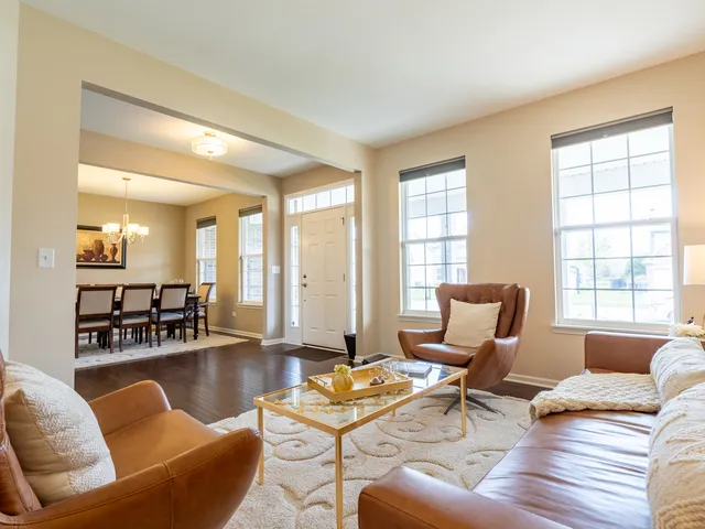 a living room with furniture and floor to ceiling windows