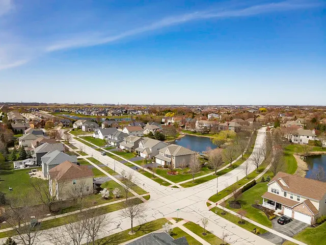 an aerial view of residential houses with outdoor space