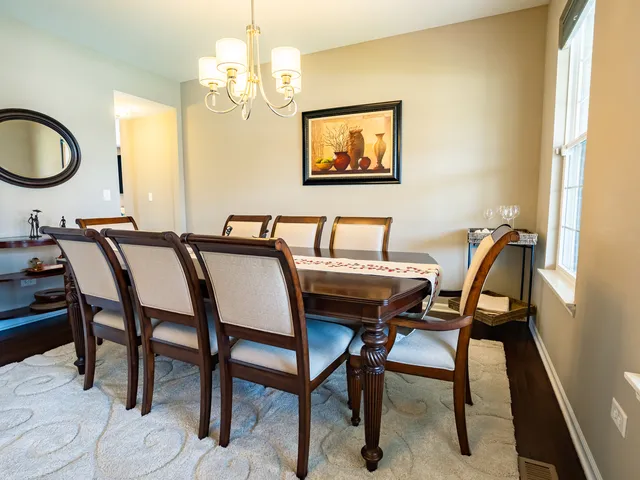 a view of a dining room with furniture and chandelier