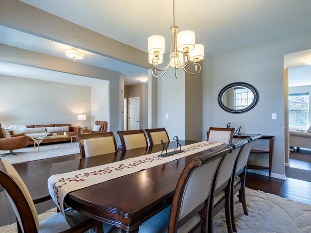 a view of a dining room with furniture and chandelier