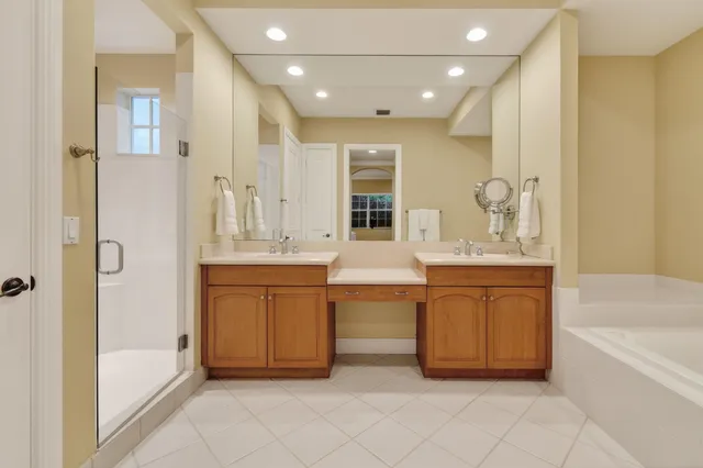 a bathroom with a bathtub sink and mirror
