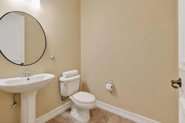 a bathroom with a toilet a sink and a mirror