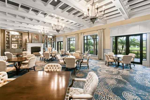 a living room with patio furniture and a large window