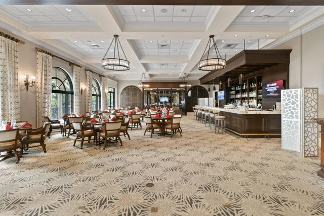 a view of a big room with dining table and chairs
