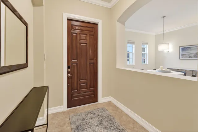 a view of a hallway with wooden floor and cabinet