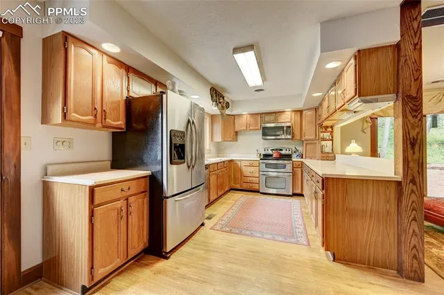 a kitchen with a refrigerator a stove top oven a sink and dishwasher