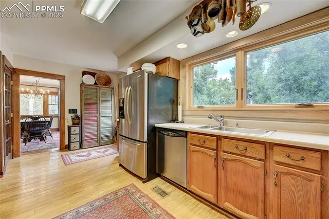 a kitchen with stainless steel appliances granite countertop a refrigerator and a sink