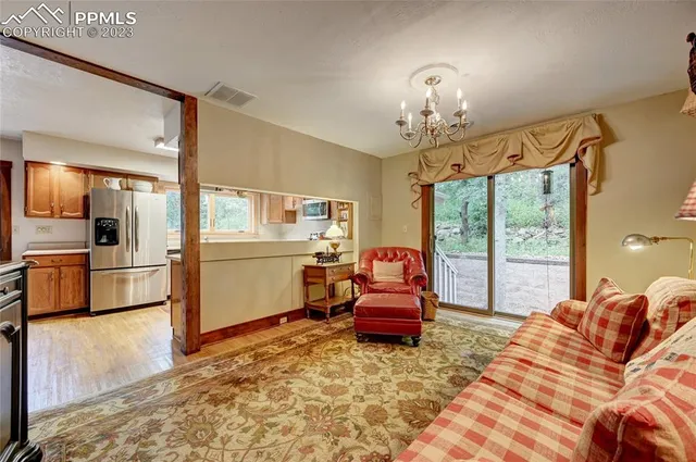 a bedroom with furniture and a large window