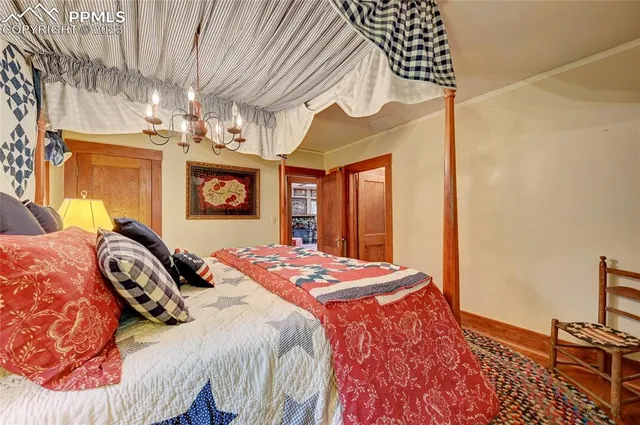 a bedroom with a bed and a chandelier