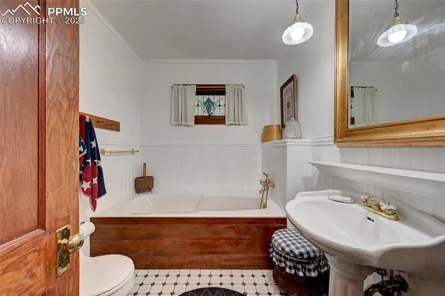 a bathroom with a sink toilet and a mirror
