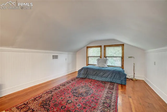 a spacious bedroom with a bed and a window