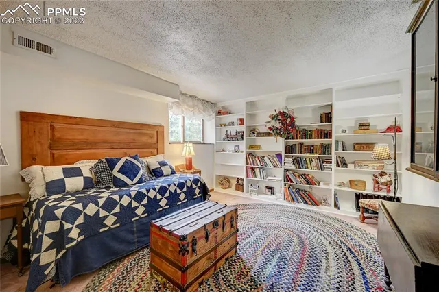 a bed room with a bed and a book shelf