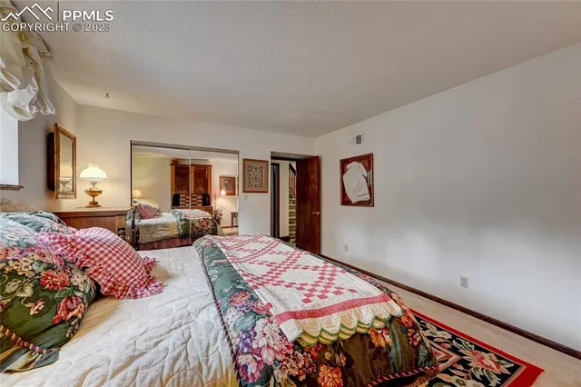 a bedroom with bed and glass door