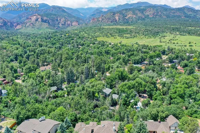 an aerial view of a house with a yard and garden