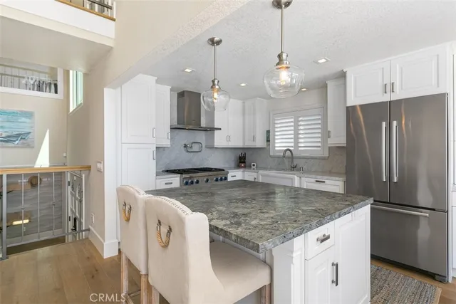 a kitchen with a table chairs stove and wooden floor
