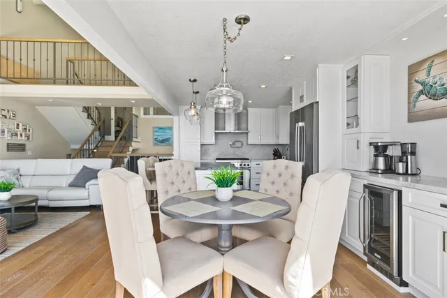 a living room with furniture a chandelier and a large window