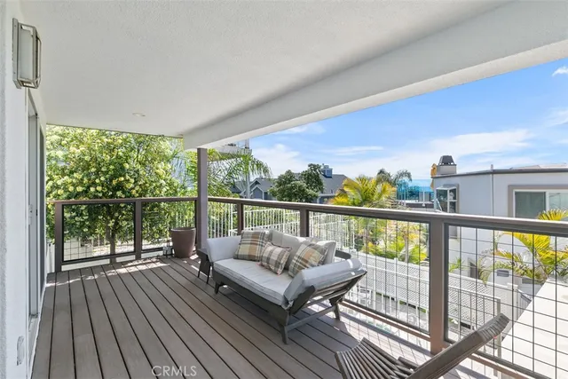 a balcony with furniture and wooden floor